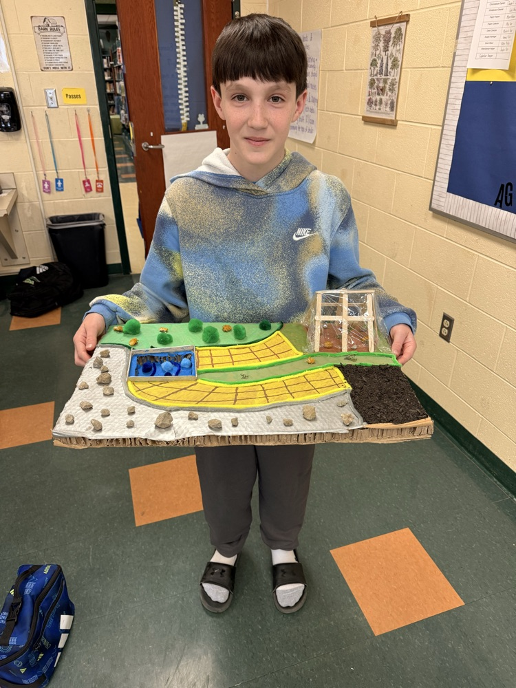 Student holding his landscape project.