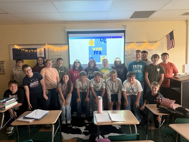 Students standing in front of a white board for a picture.