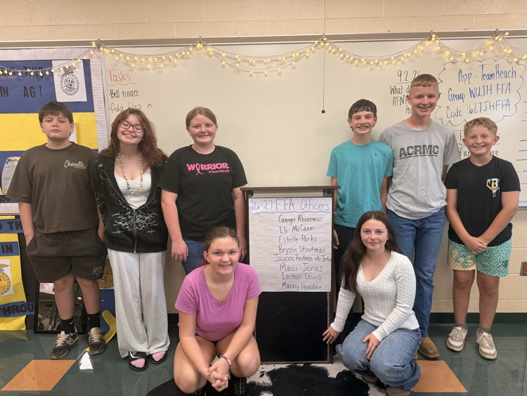 Students standing in front of a whiteboard for a picture.
