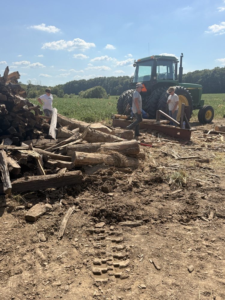 Students stacking fire wood.