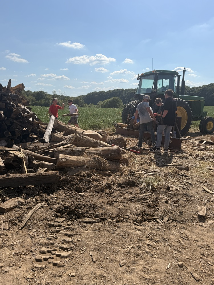 Students stacking fire wood.