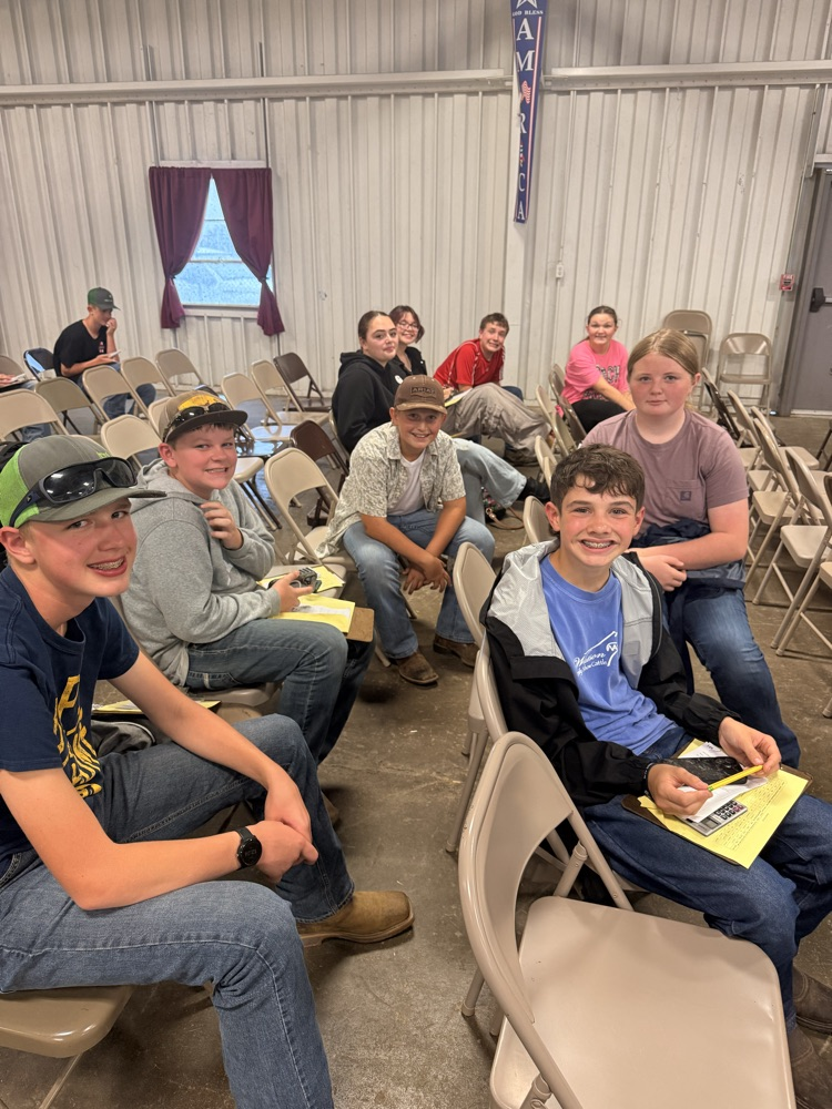 students sitting in chairs in a building