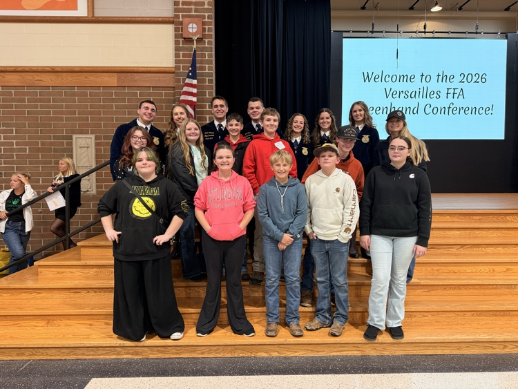 8th grade students standing in front of FFA officers.