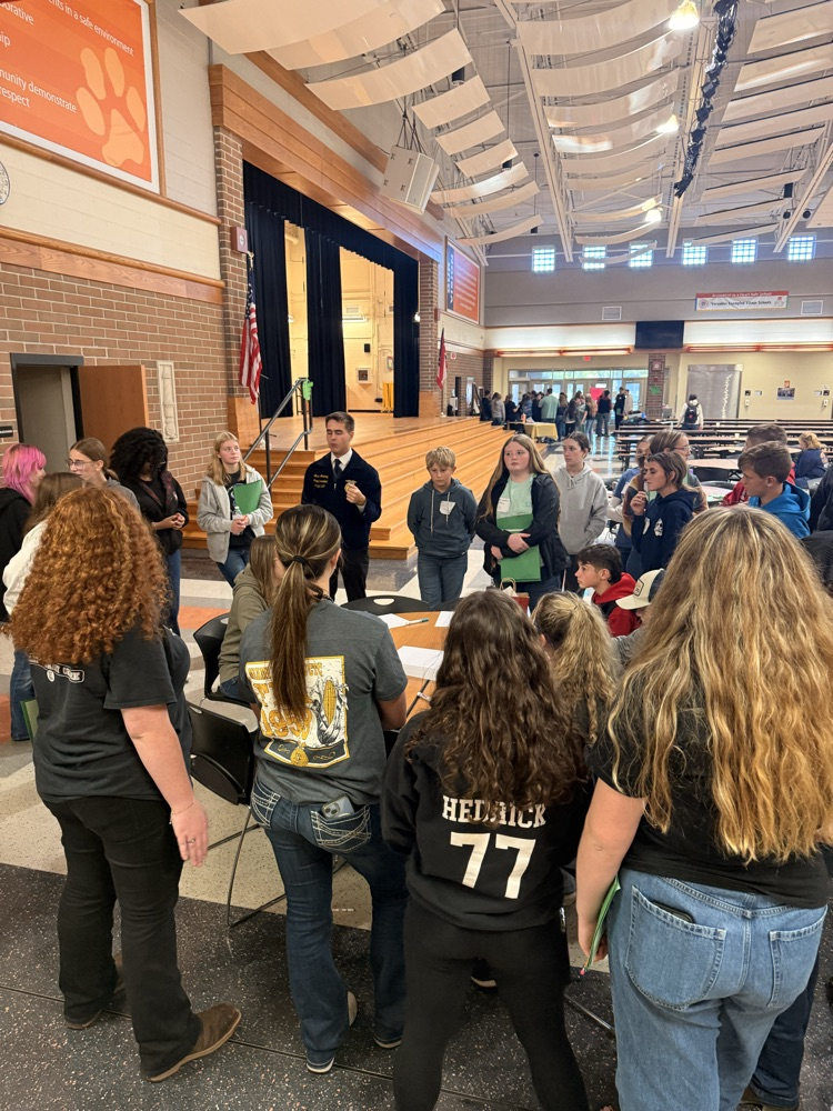 Students standing in a circle for a workshop.
