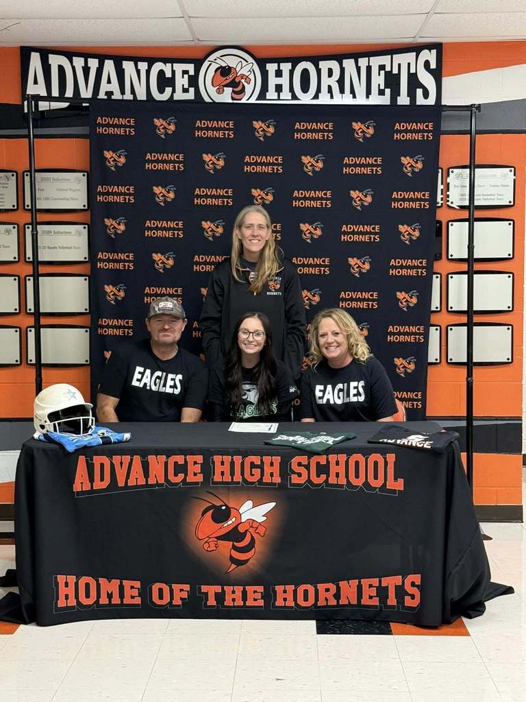Brogan Hawkins, Coach Hoffman, and Brogan's parents as she signs with Central Methodist University.
