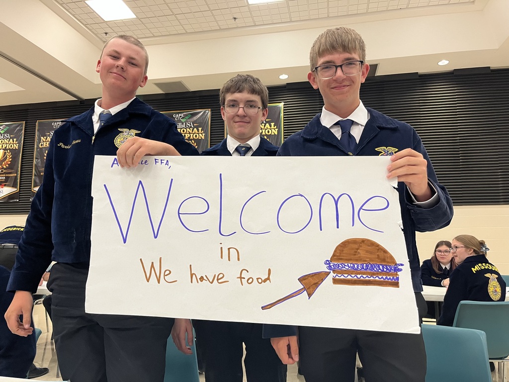 Students showing a sign they created.