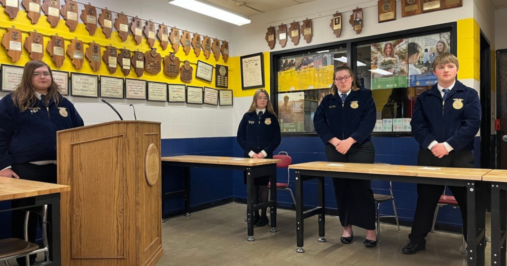 A-FC students behind podium and desks at Section 2 Parliamentary Procedure Career Development Event