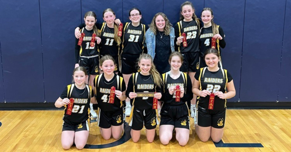 7th grade girls basketball players show their 2nd place ribbons