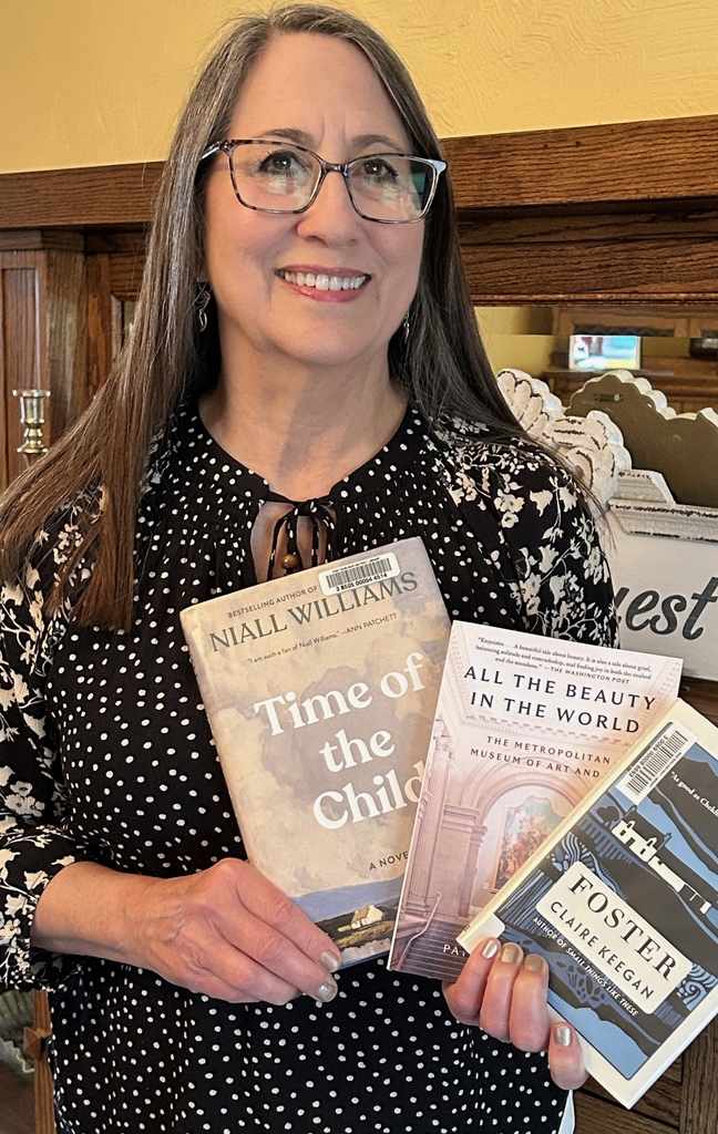 Ms. Toole holding three books