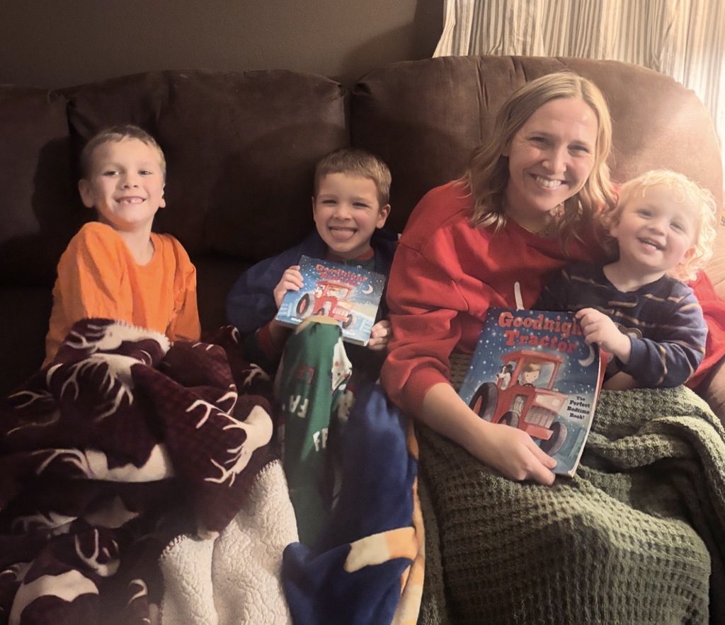 Ms. Wolf smiling with her three children. All boys. There are two books of the same title called goodnight tractor.