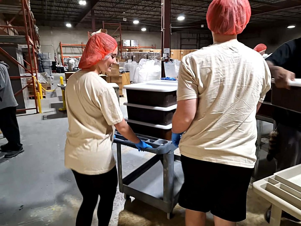 two students pushing a cart