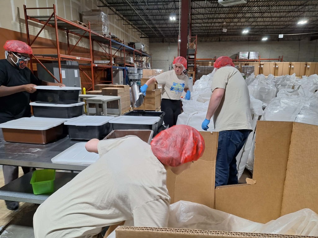 three students working in the warehouse