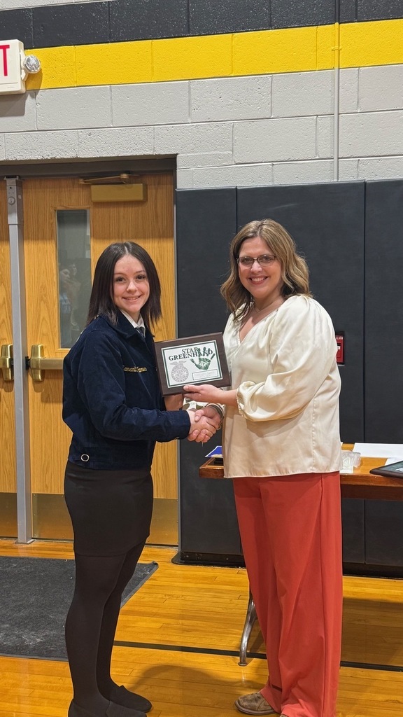 teacher giving student a certificate