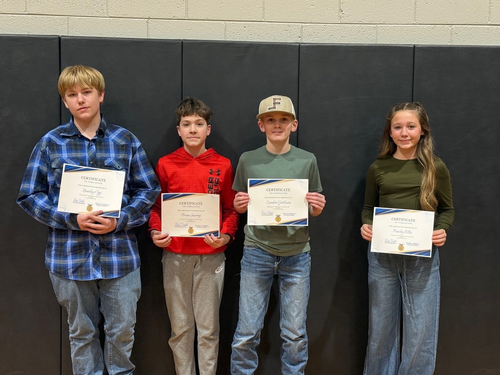 four students holding certificates