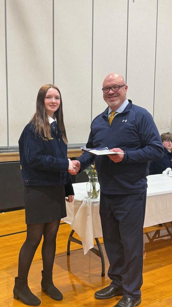 Mr. Lindy posing with student