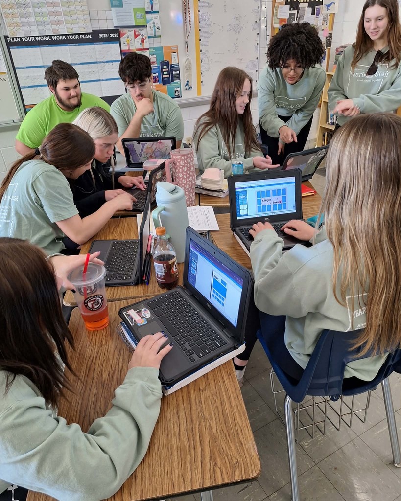 students in yearbook club working on computers to complete the yearbook