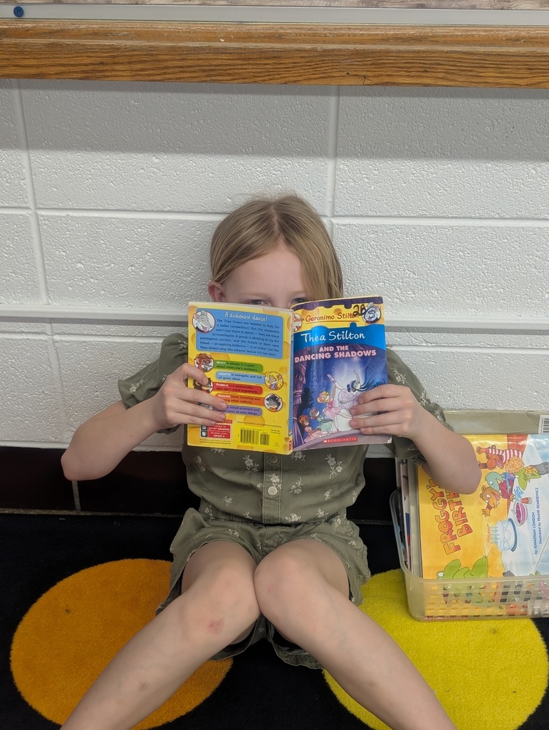 student with book in front of her book