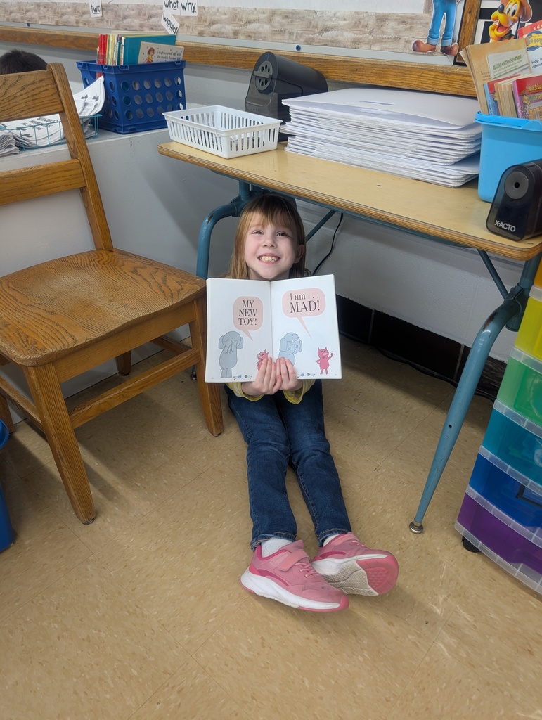 female student reading under a table