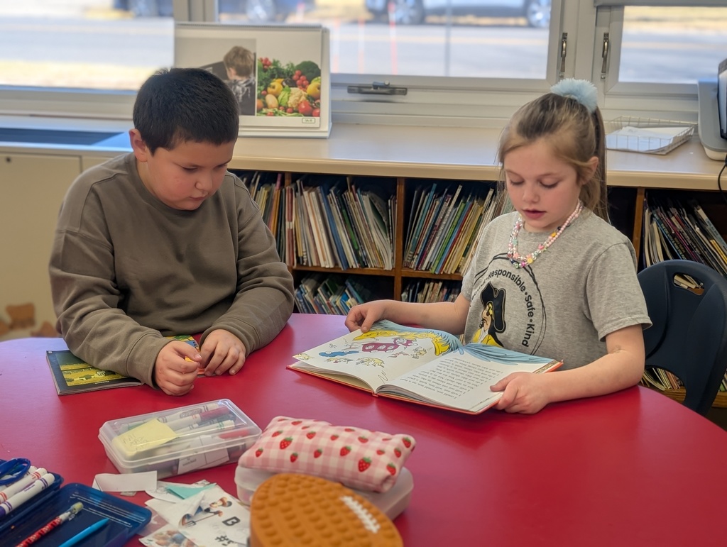 two students reading at a table