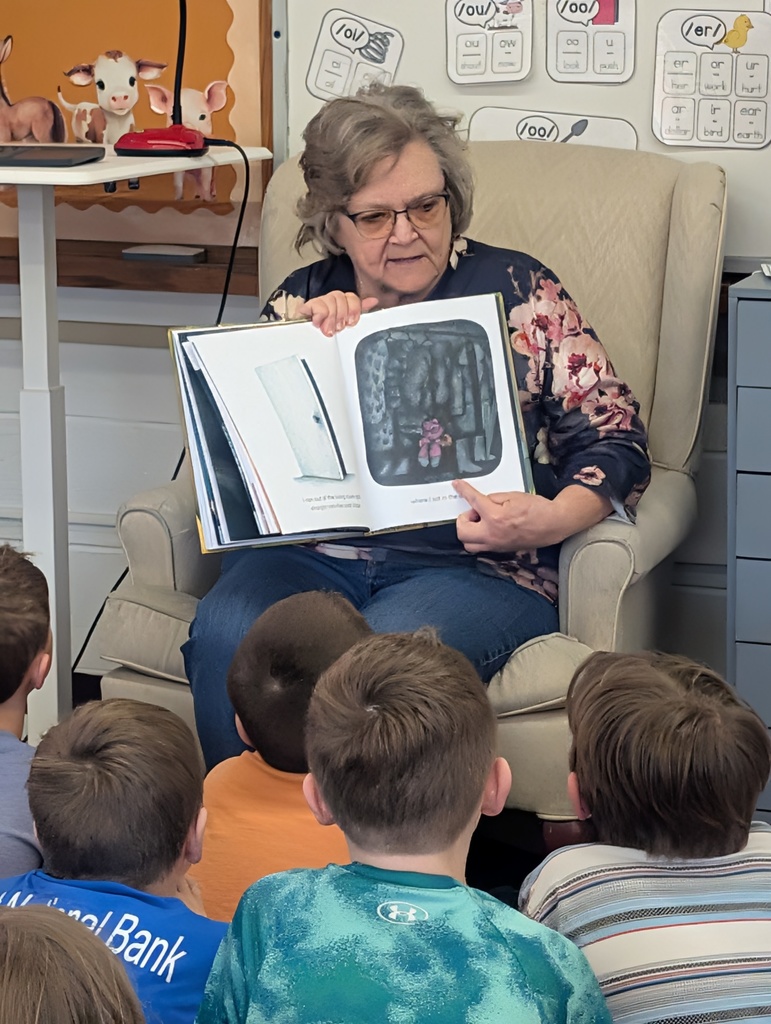 Older woman  reading to students