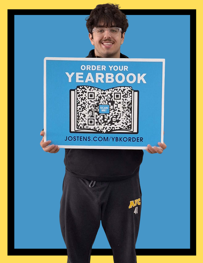 afc student holding a sign that says order your yearbook