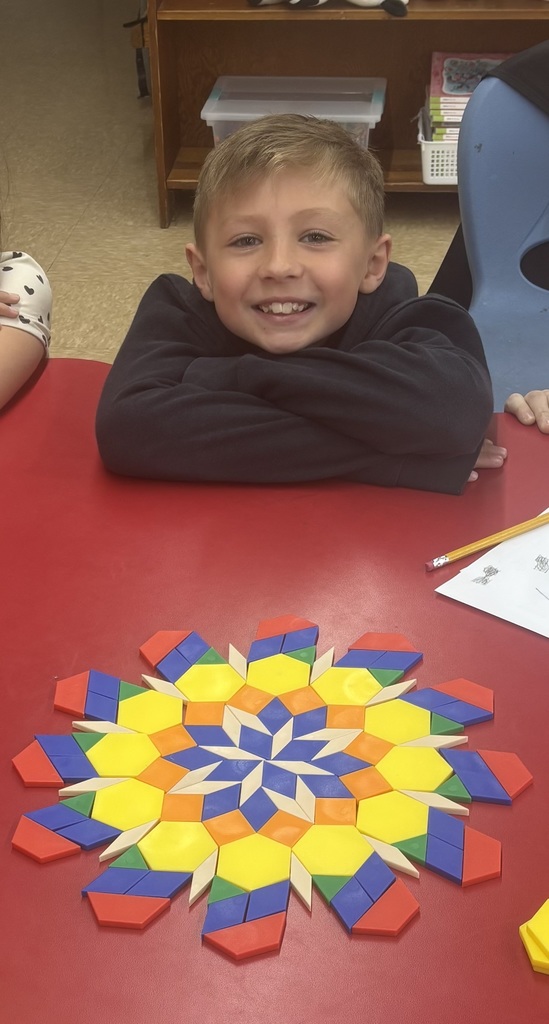 student smiling with shapes that make a flower