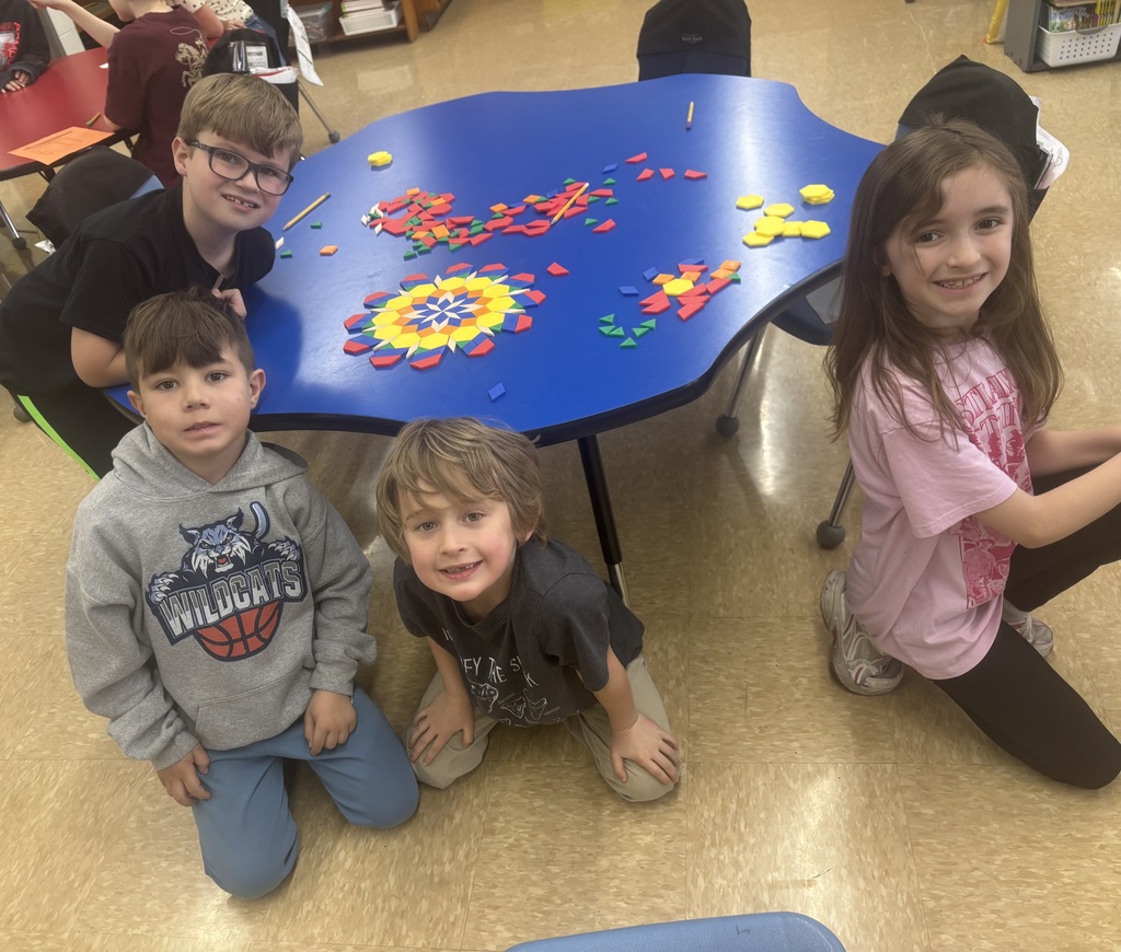 students with shape tiles making art