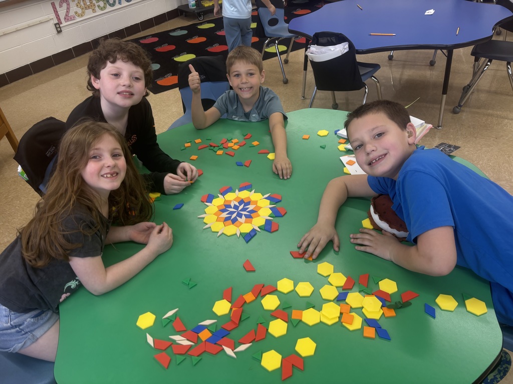 students with shape tiles making art