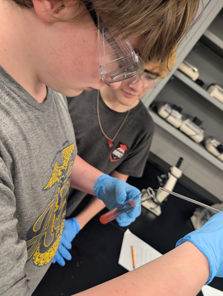 two boys holding test tubes