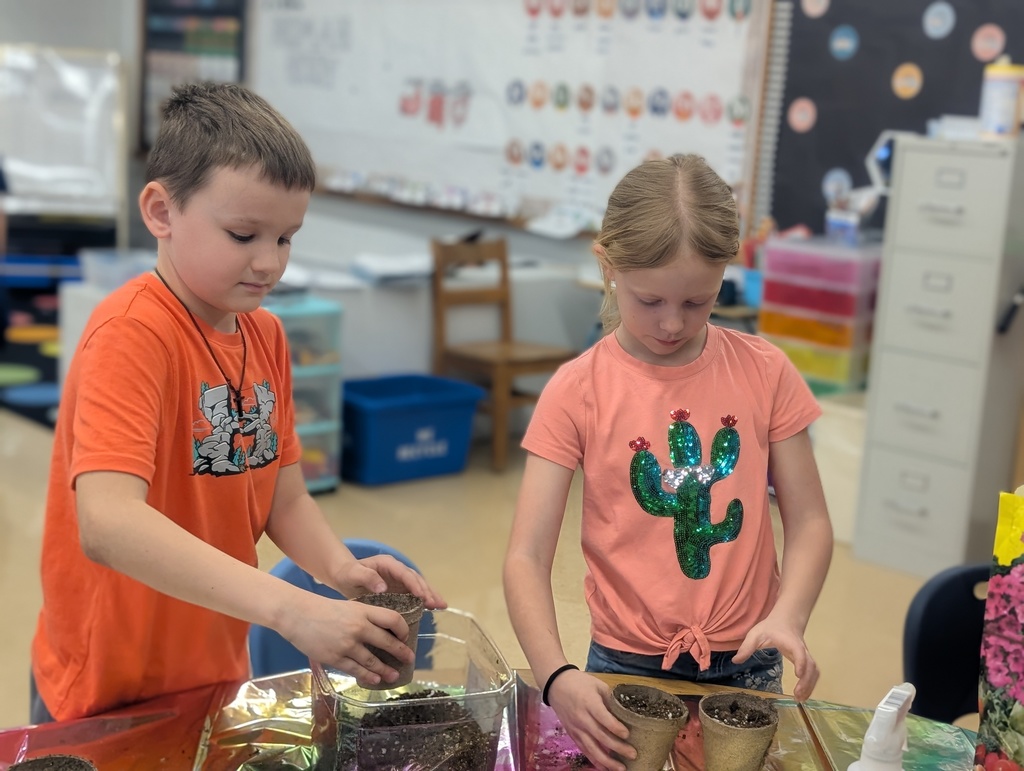male and female student packing dirt