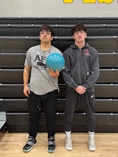 two male high school students with a bowling ball