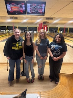group of four female students at bowling alley