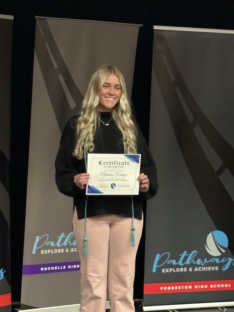 Student holding certificate posing for picture