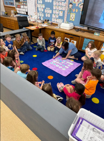 students sitting at the carpet