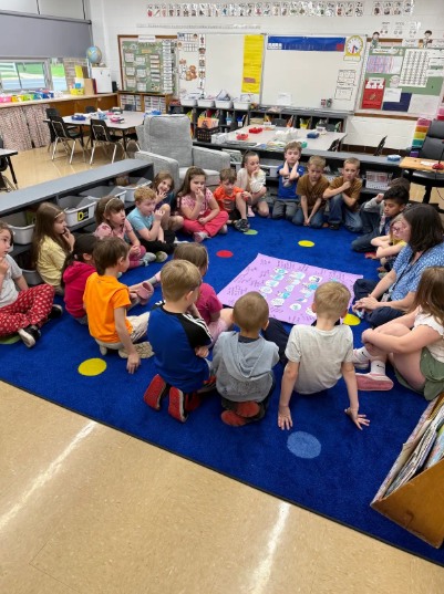 students sitting at the carpet