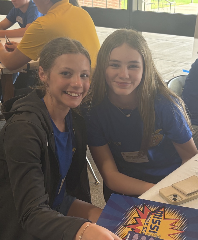 two female students sitting at a table