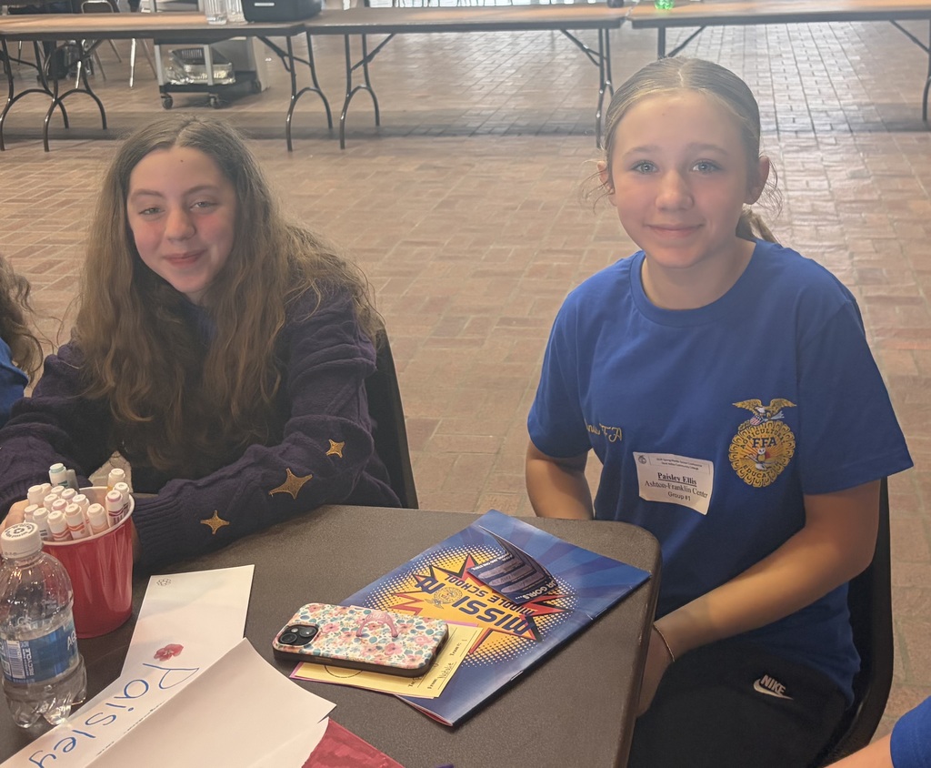 two female students sitting at a table