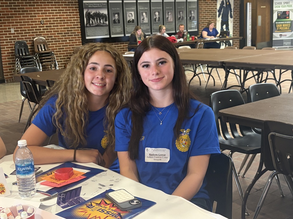 two female students sitting at a table