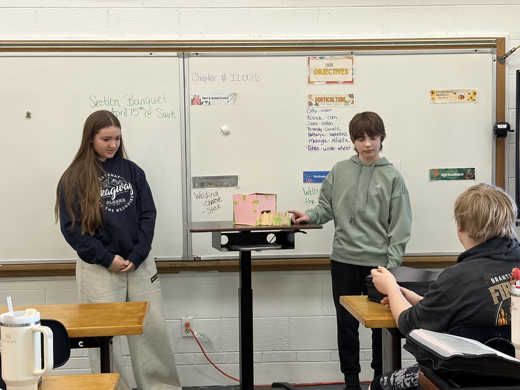 two  students presenting at front of class