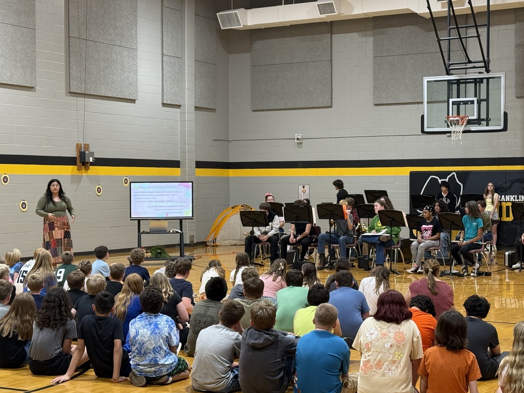 large group of students watching students perform