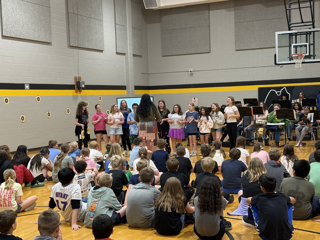 large group of students watching students perform