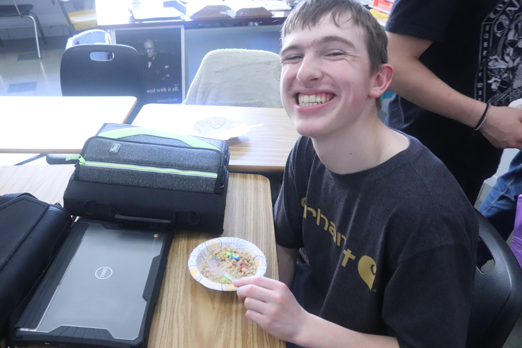 students eating cereal and posing