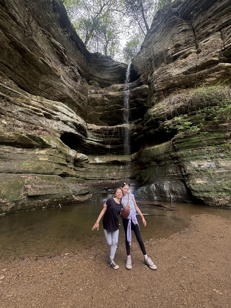 girls next to large rocks