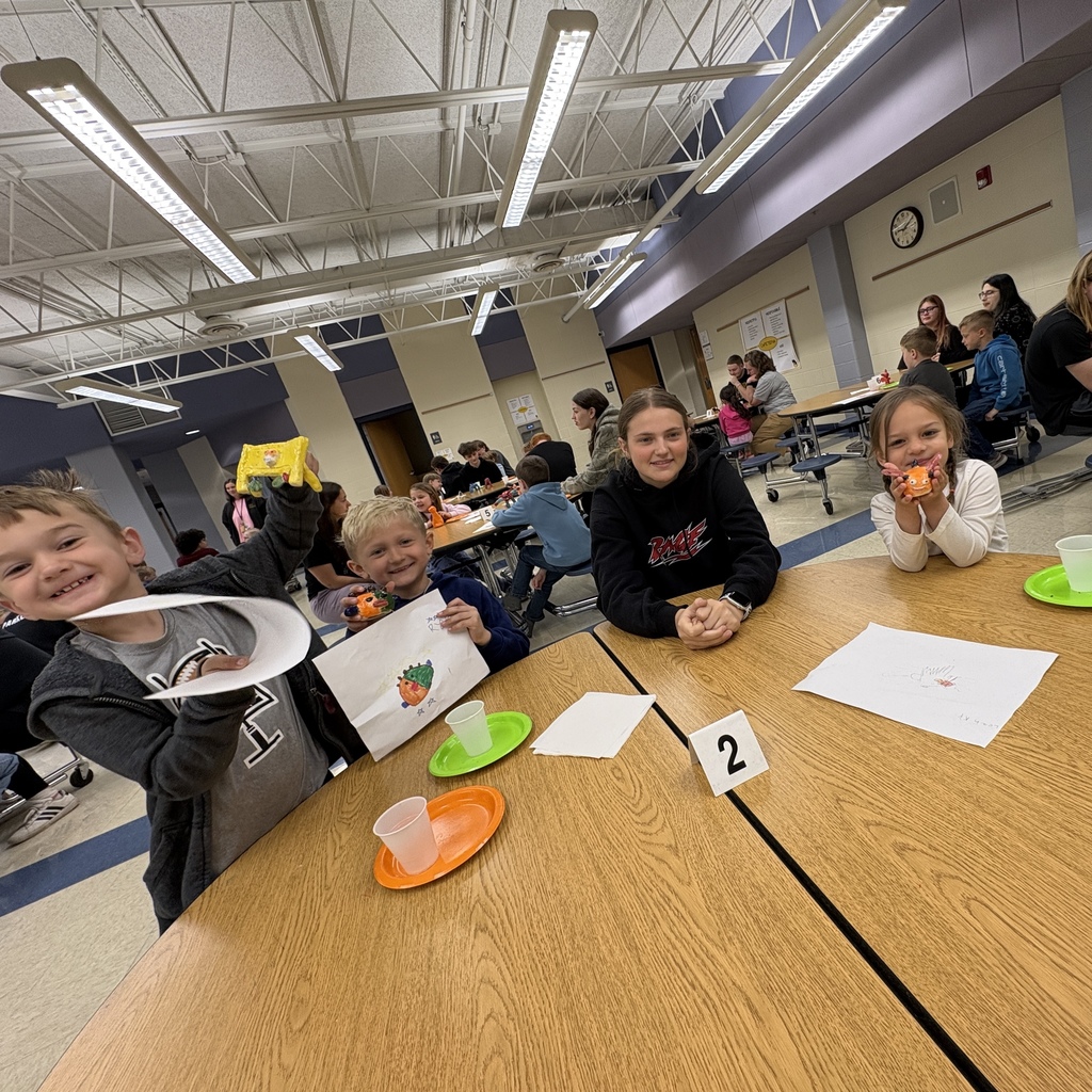 group of students at a table with their monsters