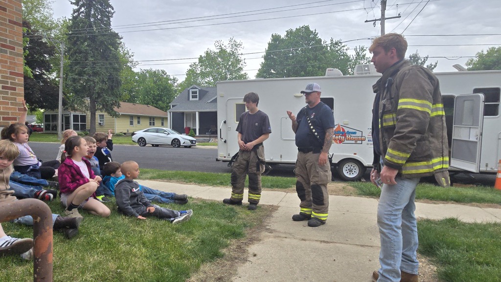 firefighters talking to students outside