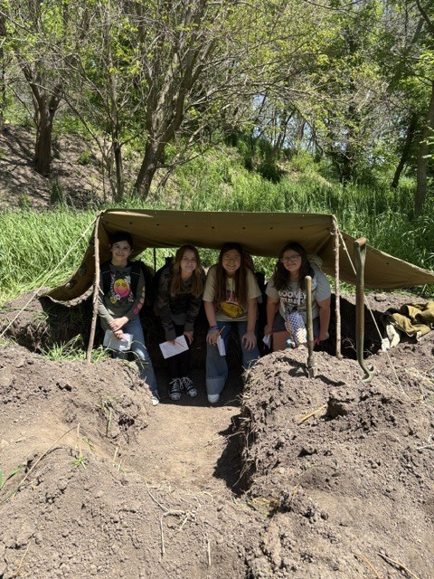 students posing under tent