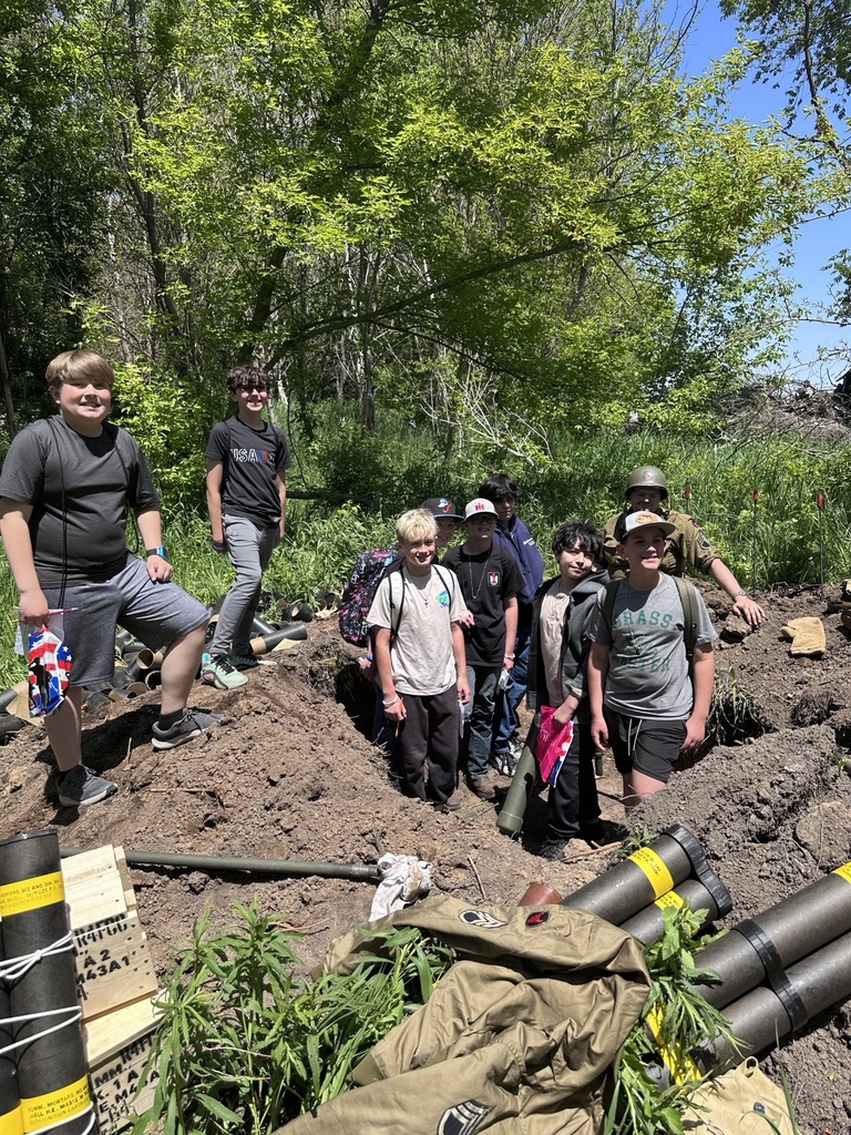 students in trenches smiling