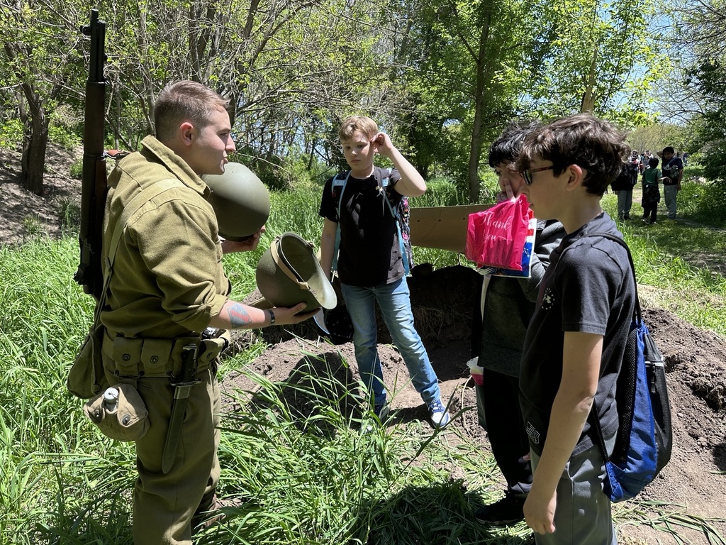 students talking with reenactment actors