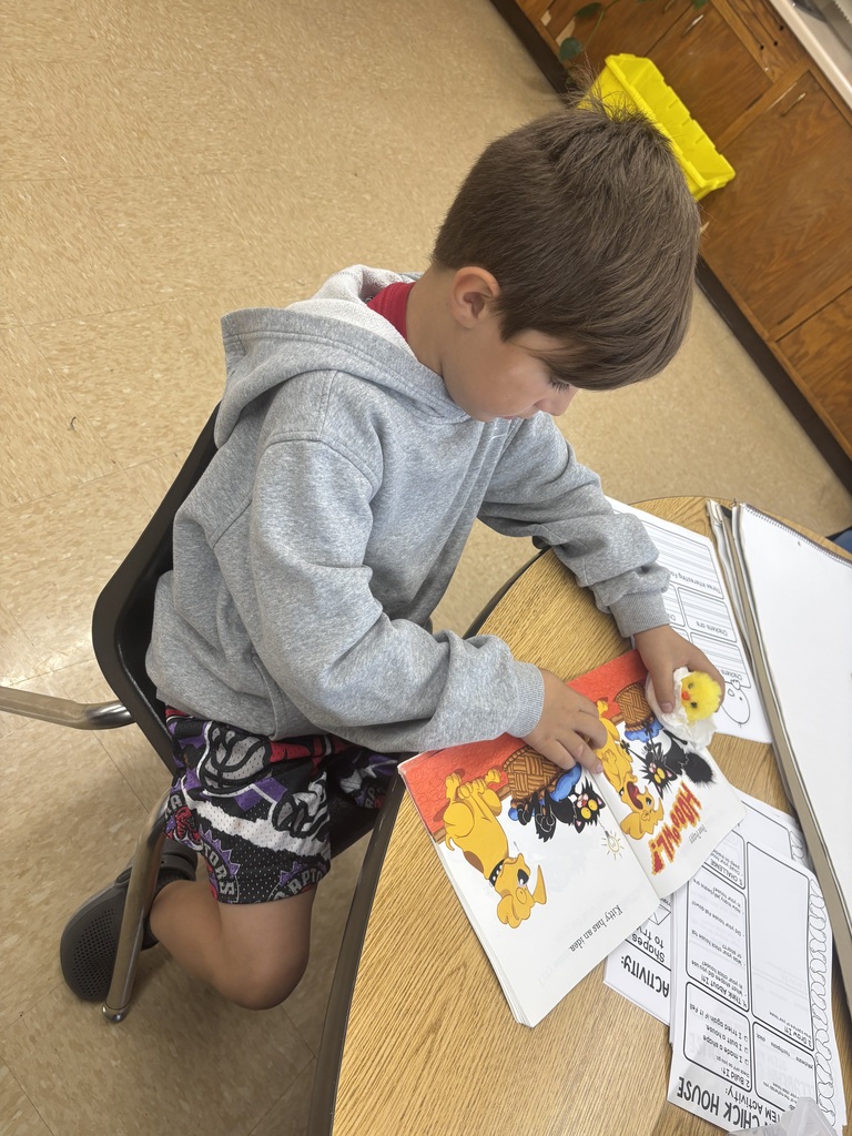 male student reading with his plush chick