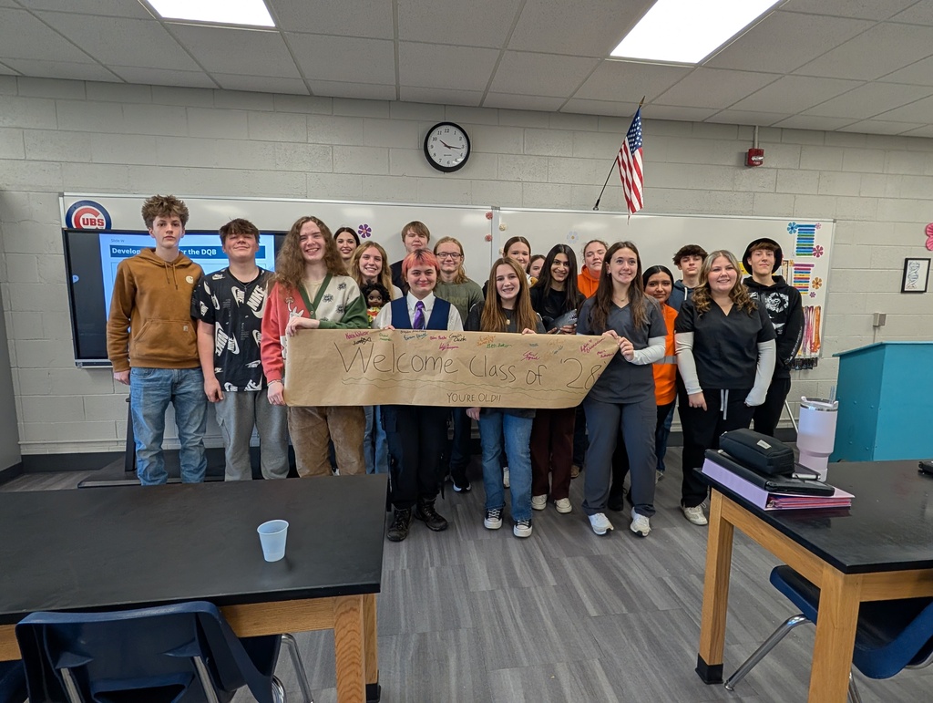 large group of students smiling and posing